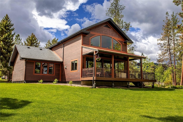 46274 Meadowlark Ln, Big Arm, MT 59910 - rear view of house featuring a yard and a wooden deck