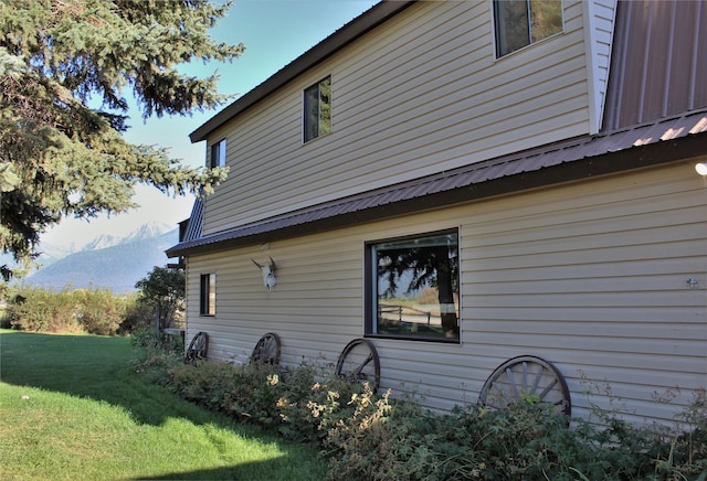 34575 Gunlock Rd, Charlo, MT 59824 - view of home's exterior featuring a lawn, a mountain view, and metal roof