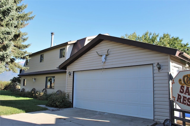 34575 Gunlock Rd, Charlo, MT 59824 - view of front of home featuring a garage, a front yard, and concrete driveway