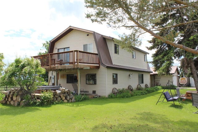 34575 Gunlock Rd, Charlo, MT 59824 - rear view of house featuring a gambrel roof, a deck, a lawn, and metal roof