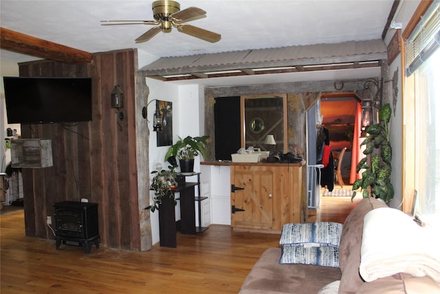 34575 Gunlock Rd, Charlo, MT 59824 - living area featuring wood finished floors, a ceiling fan, and a wood stove