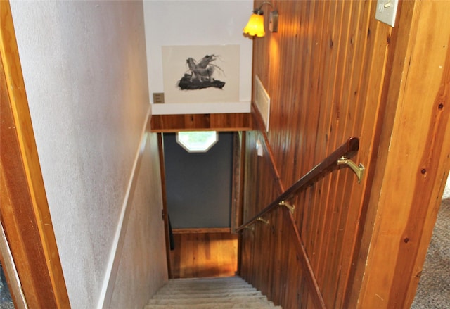 34575 Gunlock Rd, Charlo, MT 59824 - staircase featuring wooden walls and carpet flooring