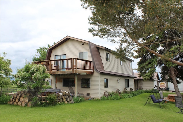 34575 Gunlock Rd, Charlo, MT 59824 - back of house featuring a gambrel roof, a wooden deck, and a yard