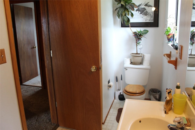 34575 Gunlock Rd, Charlo, MT 59824 - bathroom with toilet, baseboards, vanity, and tile patterned floors