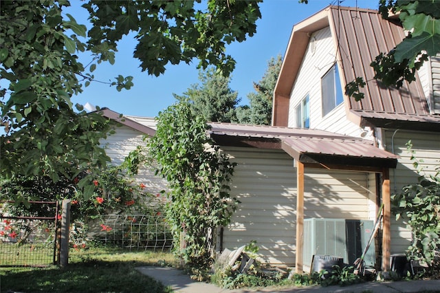 34575 Gunlock Rd, Charlo, MT 59824 - view of side of home featuring a gambrel roof, metal roof, and cooling unit