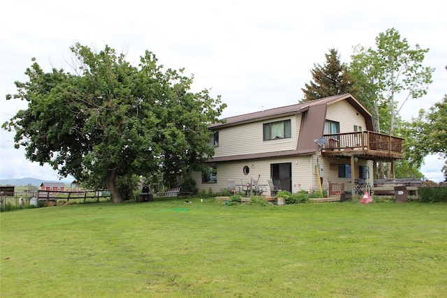 34575 Gunlock Rd, Charlo, MT 59824 - back of property featuring a gambrel roof and a deck
