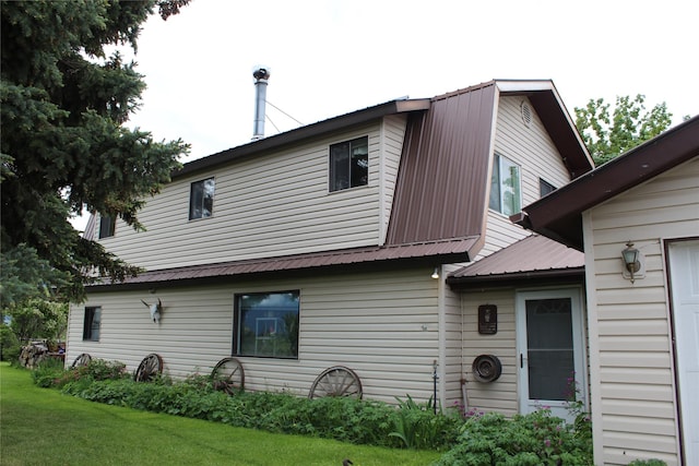 34575 Gunlock Rd, Charlo, MT 59824 - view of property exterior with metal roof and a yard