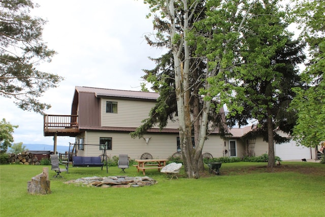 34575 Gunlock Rd, Charlo, MT 59824 - rear view of property with a yard, metal roof, and a wooden deck