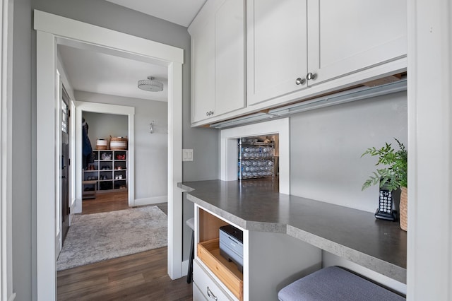 1221 Majestic View Ln, Kalispell, MT 59901 - kitchen featuring dark wood-type flooring, white cabinetry, dark countertops, and baseboards