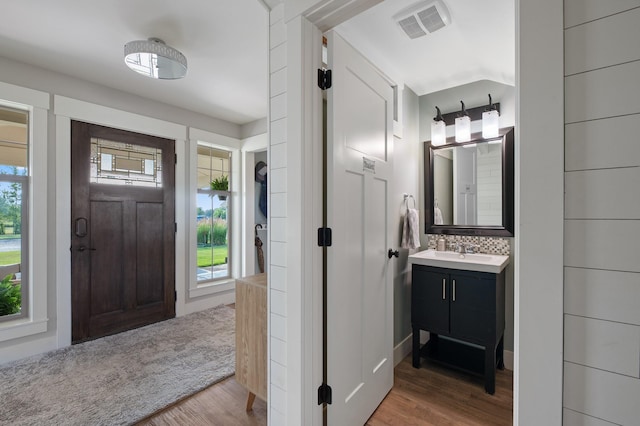 1221 Majestic View Ln, Kalispell, MT 59901 - bathroom with wood finished floors, vanity, and tasteful backsplash