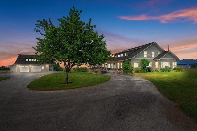 1221 Majestic View Ln, Kalispell, MT 59901 - view of front of home with curved driveway, a front yard, and a garage
