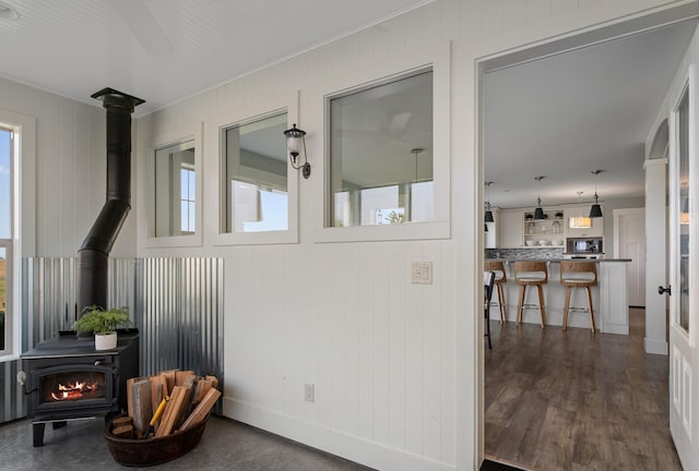 1221 Majestic View Ln, Kalispell, MT 59901 - exterior space featuring a wood stove, ornamental molding, and wood walls