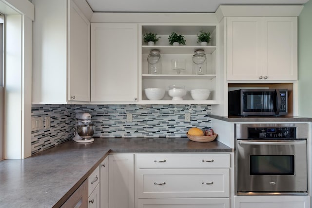 1221 Majestic View Ln, Kalispell, MT 59901 - kitchen with appliances with stainless steel finishes, open shelves, dark countertops, and tasteful backsplash
