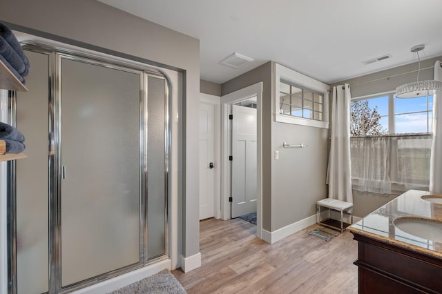 1221 Majestic View Ln, Kalispell, MT 59901 - full bath with a stall shower, vanity, wood finished floors, and baseboards