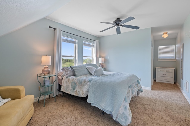 1221 Majestic View Ln, Kalispell, MT 59901 - carpeted bedroom with multiple windows, a ceiling fan, baseboards, and lofted ceiling