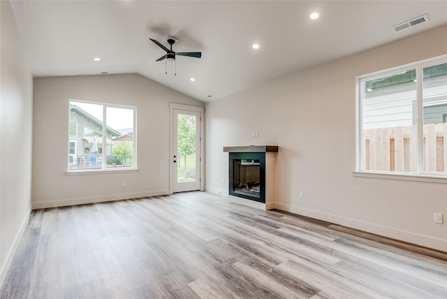 1050 Mill Creek Dr, Bigfork, MT 59911 - unfurnished living room featuring a ceiling fan, a glass covered fireplace, wood finished floors, vaulted ceiling, and recessed lighting