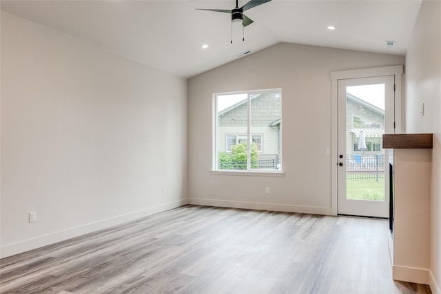 1050 Mill Creek Dr, Bigfork, MT 59911 - unfurnished living room with ceiling fan, plenty of natural light, light wood-style floors, lofted ceiling, and baseboards