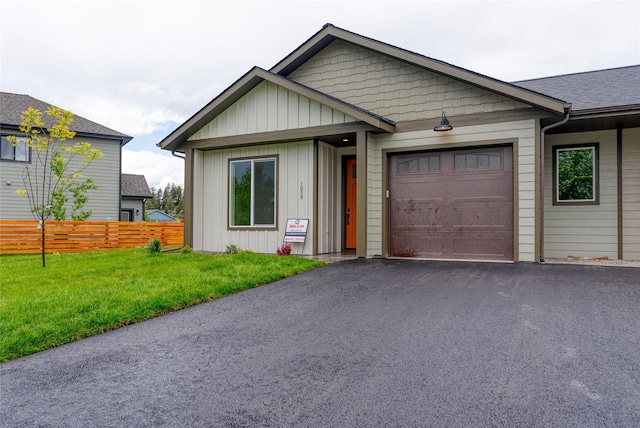 1050 Mill Creek Dr, Bigfork, MT 59911 - view of front facade featuring an attached garage, driveway, and board and batten siding