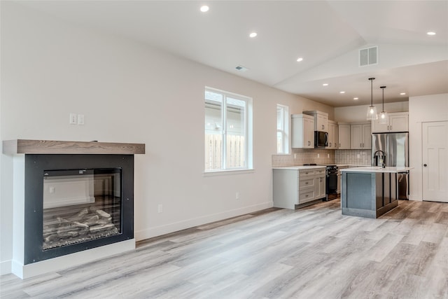 1050 Mill Creek Dr, Bigfork, MT 59911 - kitchen featuring electric range, light countertops, light wood-type flooring, tasteful backsplash, and recessed lighting