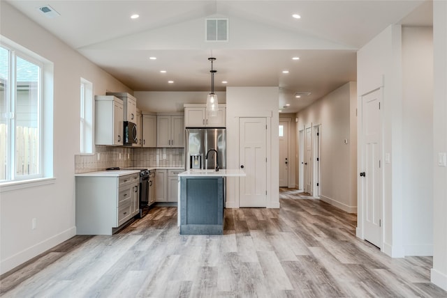 1050 Mill Creek Dr, Bigfork, MT 59911 - kitchen with stainless steel appliances, gray cabinets, light countertops, light wood-type flooring, and recessed lighting