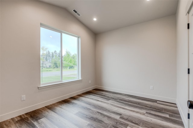 1050 Mill Creek Dr, Bigfork, MT 59911 - spare room with wood finished floors, baseboards, lofted ceiling, and recessed lighting