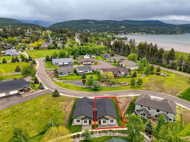 1050 Mill Creek Dr, Bigfork, MT 59911 - aerial perspective of suburban area featuring property parcel outlined and a water and mountain view
