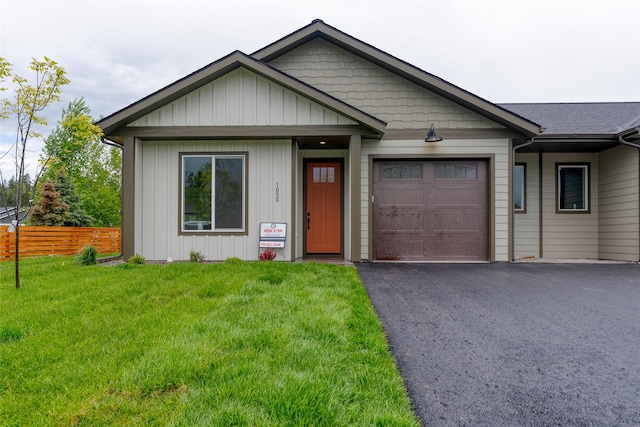 1050 Mill Creek Dr, Bigfork, MT 59911 - view of front of property with an attached garage, driveway, and board and batten siding