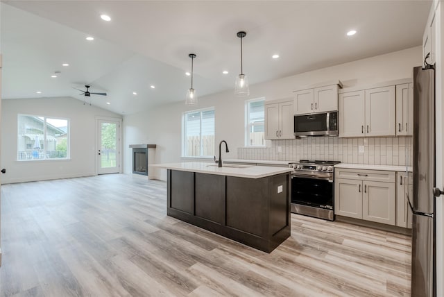 1050 Mill Creek Dr, Bigfork, MT 59911 - kitchen featuring appliances with stainless steel finishes, a sink, light countertops, tasteful backsplash, and ceiling fan