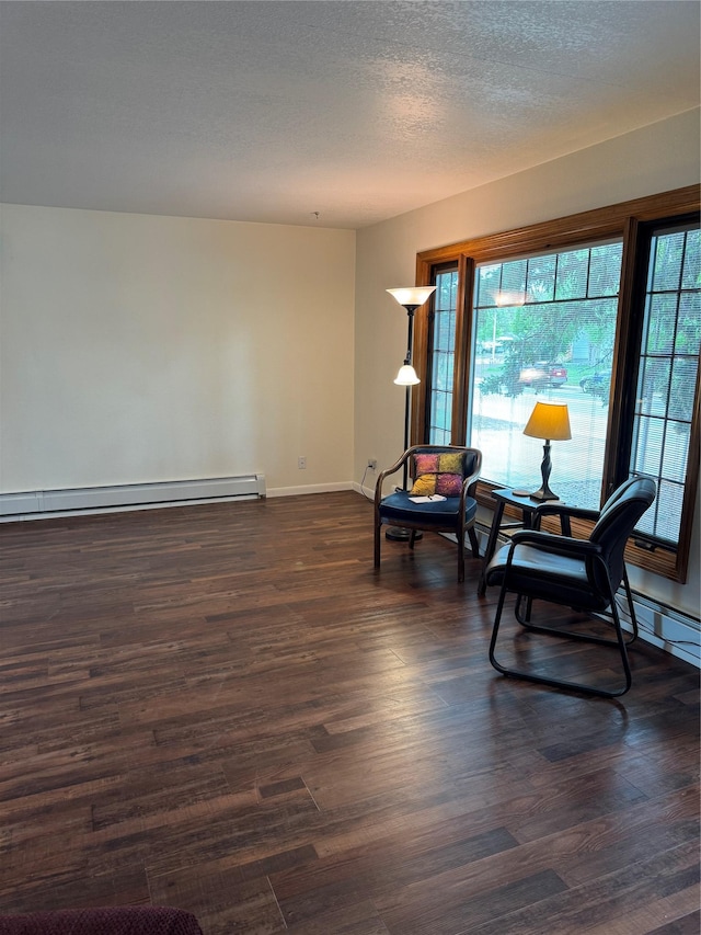3115 8th Ave N, Great Falls, MT 59401 - living area featuring a baseboard radiator and dark wood-style flooring