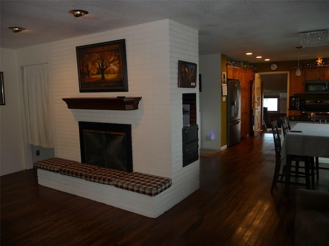 3115 8th Ave N, Great Falls, MT 59401 - living area featuring a brick fireplace, dark wood-type flooring, baseboards, and recessed lighting