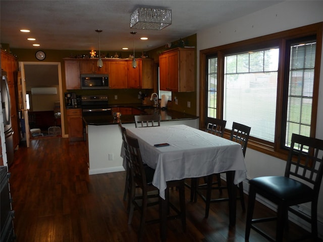 3115 8th Ave N, Great Falls, MT 59401 - kitchen featuring stainless steel appliances, a peninsula, healthy amount of natural light, dark wood-type flooring, and recessed lighting