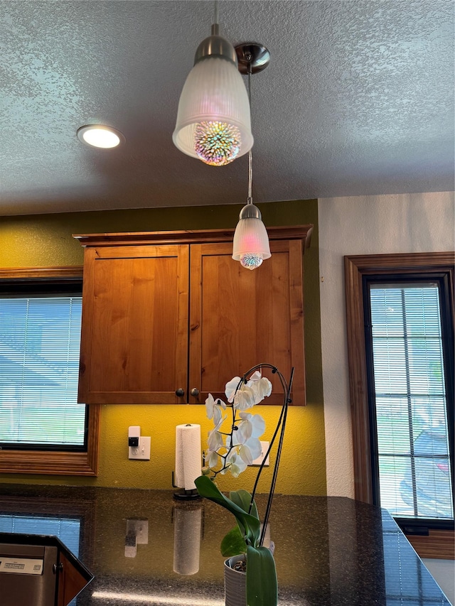 3115 8th Ave N, Great Falls, MT 59401 - kitchen view of a textured ceiling, decorative light fixtures, brown cabinets, and recessed lighting