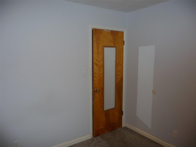 3115 8th Ave N, Great Falls, MT 59401 - empty room with dark colored carpet and baseboards