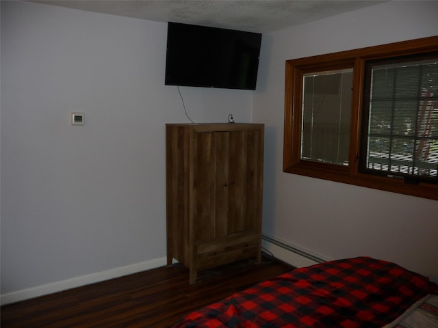 3115 8th Ave N, Great Falls, MT 59401 - unfurnished bedroom featuring a baseboard heating unit, wood finished floors, and baseboards