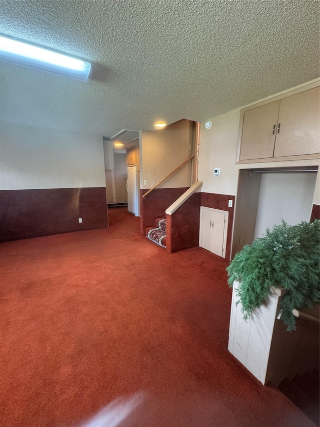 3115 8th Ave N, Great Falls, MT 59401 - basement with a textured ceiling, carpet floors, freestanding refrigerator, and stairway