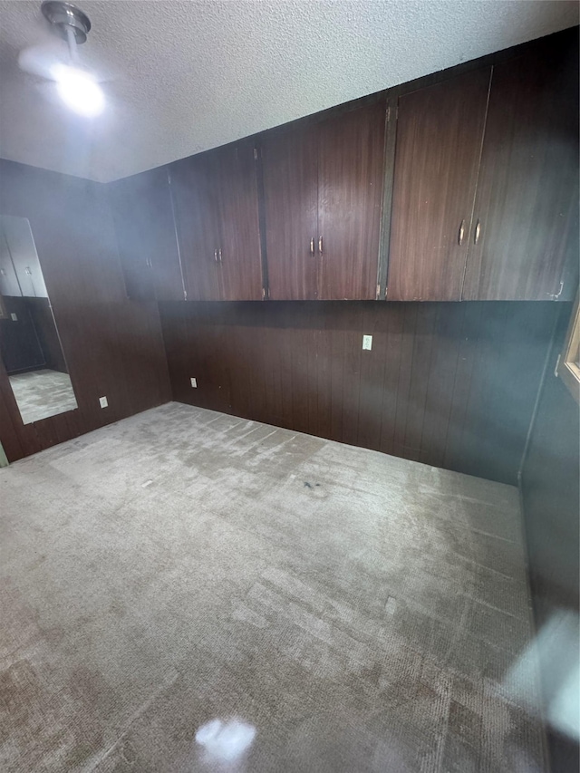 3115 8th Ave N, Great Falls, MT 59401 - carpeted empty room featuring a textured ceiling and wooden walls