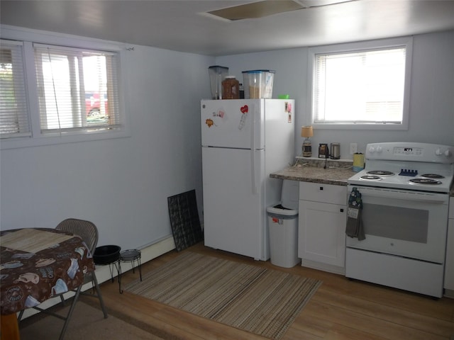 3115 8th Ave N, Great Falls, MT 59401 - kitchen featuring white appliances, light wood finished floors, and plenty of natural light