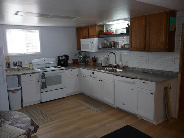 3115 8th Ave N, Great Falls, MT 59401 - kitchen with white appliances, a sink, decorative backsplash, light wood finished floors, and white cabinetry