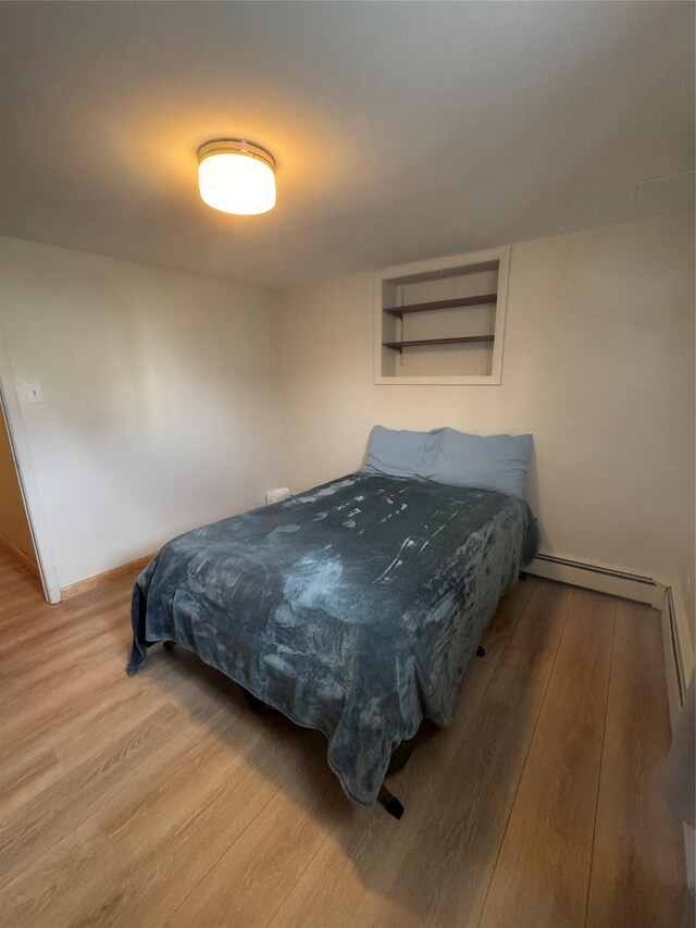 3115 8th Ave N, Great Falls, MT 59401 - bedroom with wood finished floors and a baseboard radiator
