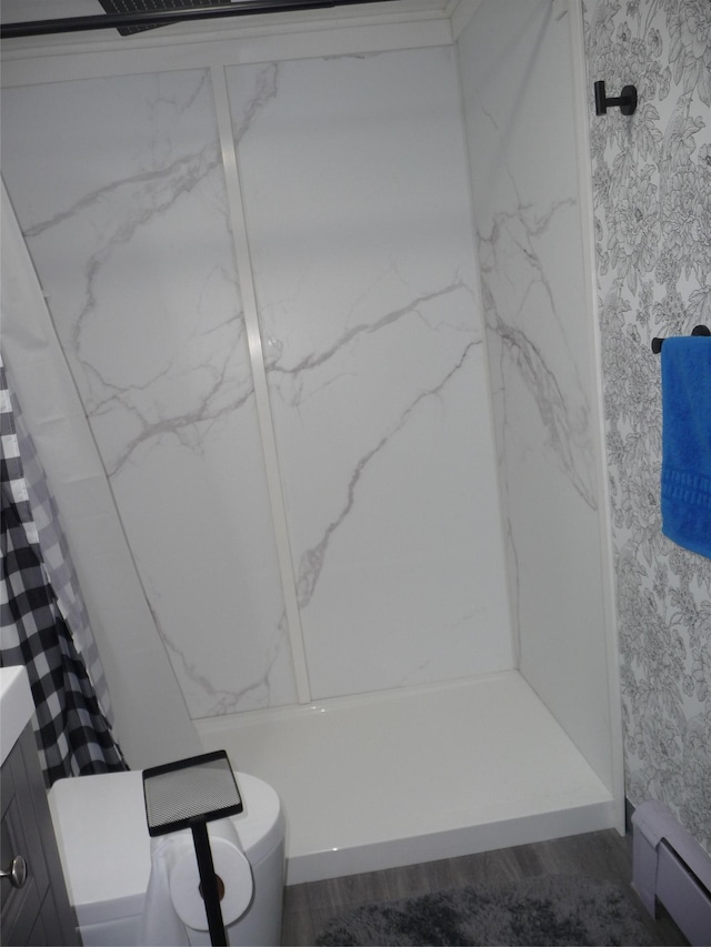 3115 8th Ave N, Great Falls, MT 59401 - full bath featuring toilet, a shower with shower curtain, wallpapered walls, wood finished floors, and a baseboard radiator