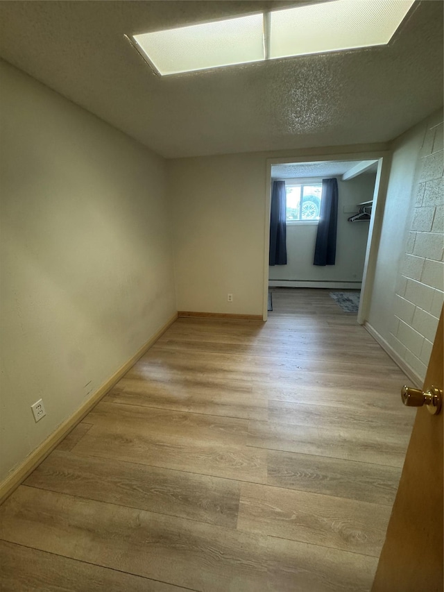 3115 8th Ave N, Great Falls, MT 59401 - unfurnished room with light wood-type flooring and a baseboard radiator