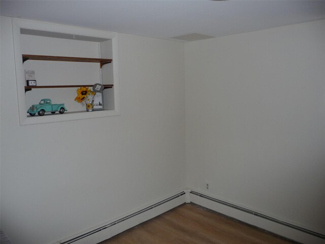 3115 8th Ave N, Great Falls, MT 59401 - empty room with wood finished floors and a baseboard radiator