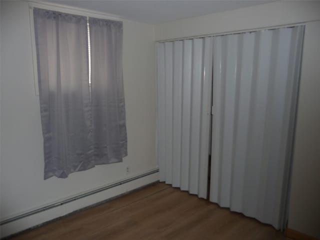3115 8th Ave N, Great Falls, MT 59401 - unfurnished room with baseboard heating and wood finished floors