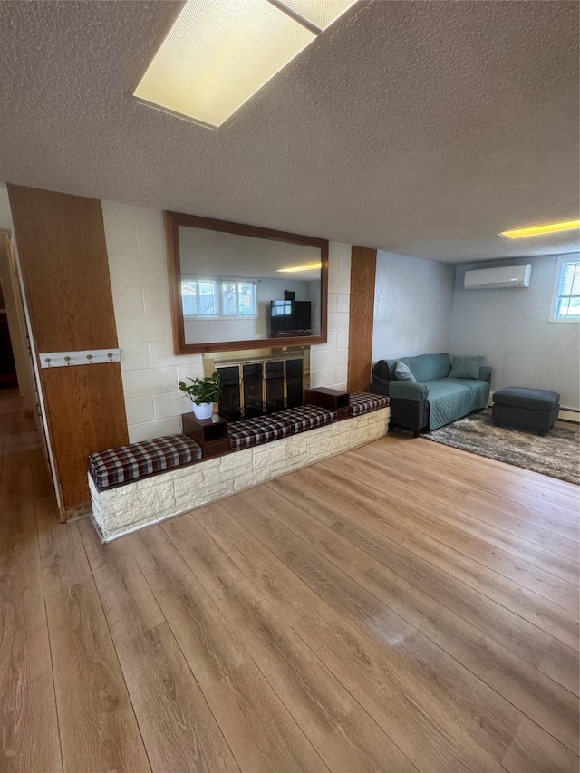 3115 8th Ave N, Great Falls, MT 59401 - living room with a wall mounted AC, wood-type flooring, and a textured ceiling