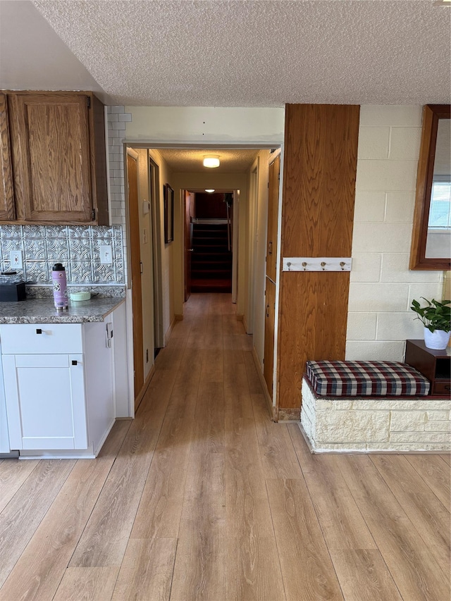 3115 8th Ave N, Great Falls, MT 59401 - kitchen featuring a textured ceiling, light wood-type flooring, decorative backsplash, and white cabinets