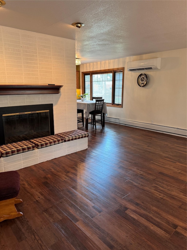 3115 8th Ave N, Great Falls, MT 59401 - living room featuring a wall mounted AC, a baseboard radiator, wood finished floors, a fireplace, and a textured ceiling