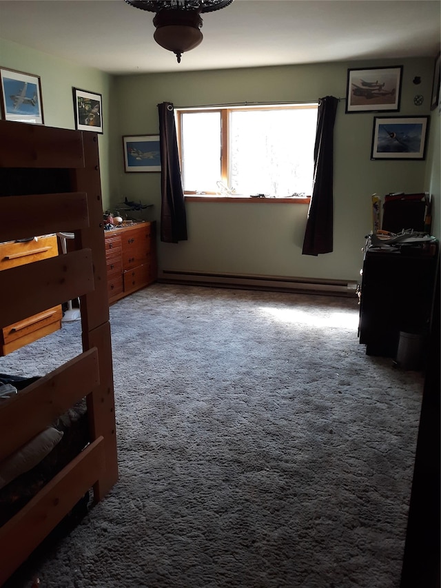 314 4th Ave NE, Cut Bank, MT 59427 - bedroom with carpet floors and a baseboard heating unit