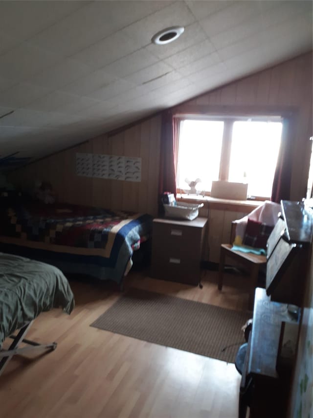 314 4th Ave NE, Cut Bank, MT 59427 - bedroom featuring vaulted ceiling, wood finished floors, and wooden walls