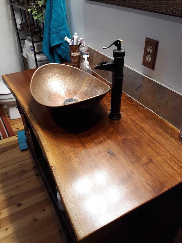 314 4th Ave NE, Cut Bank, MT 59427 - bathroom view of wood finished floors, a sink, and toilet