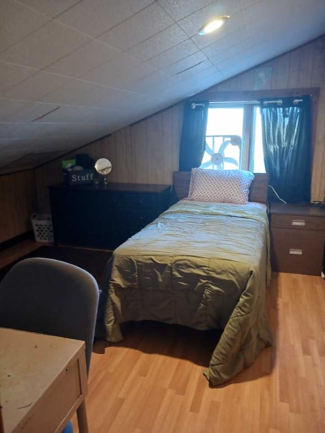 314 4th Ave NE, Cut Bank, MT 59427 - bedroom featuring wood finished floors, vaulted ceiling, and wood walls